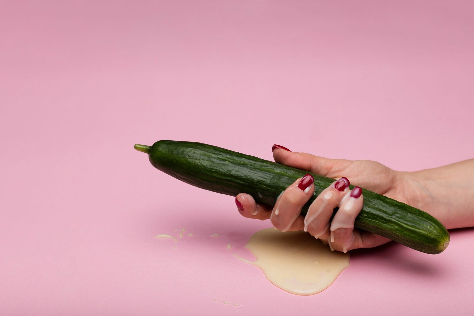 ladies hand holding a cucumber