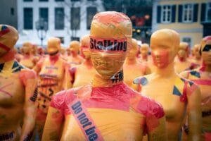 woman in yellow and pink outfit made of tape